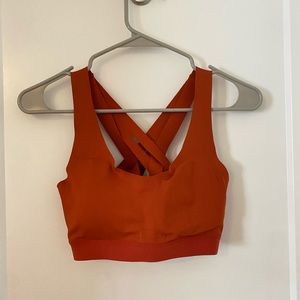 Orange “All in Motion” sports bra with crossed back